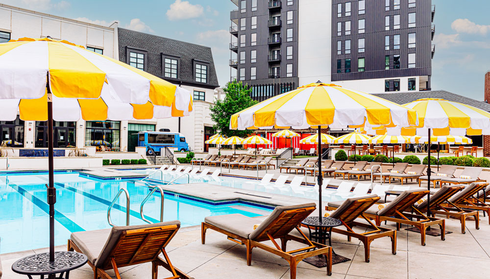 Chairs and umbrellas by the pool at Kimpton Cottonwood Hotel