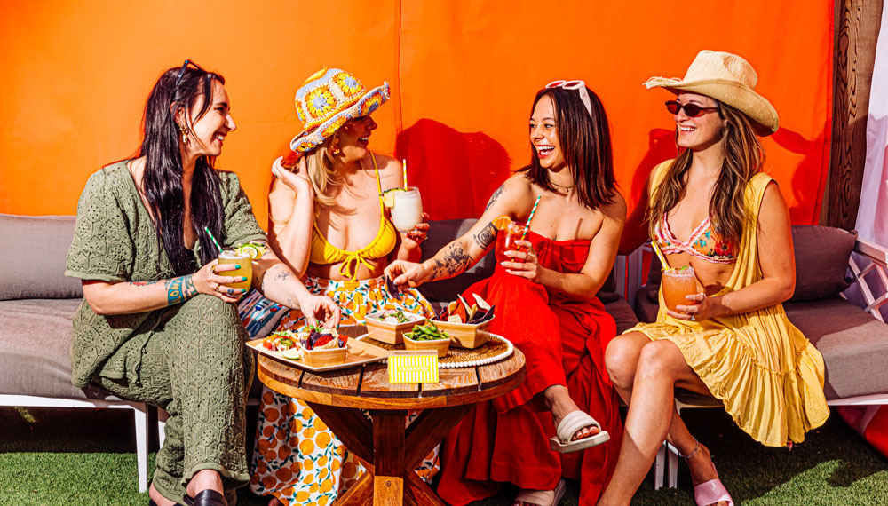 4 women enjoy cocktails by the pool at Kimpton Cottonwood Hotel