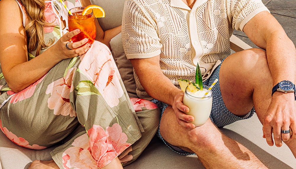 man and woman with cocktails