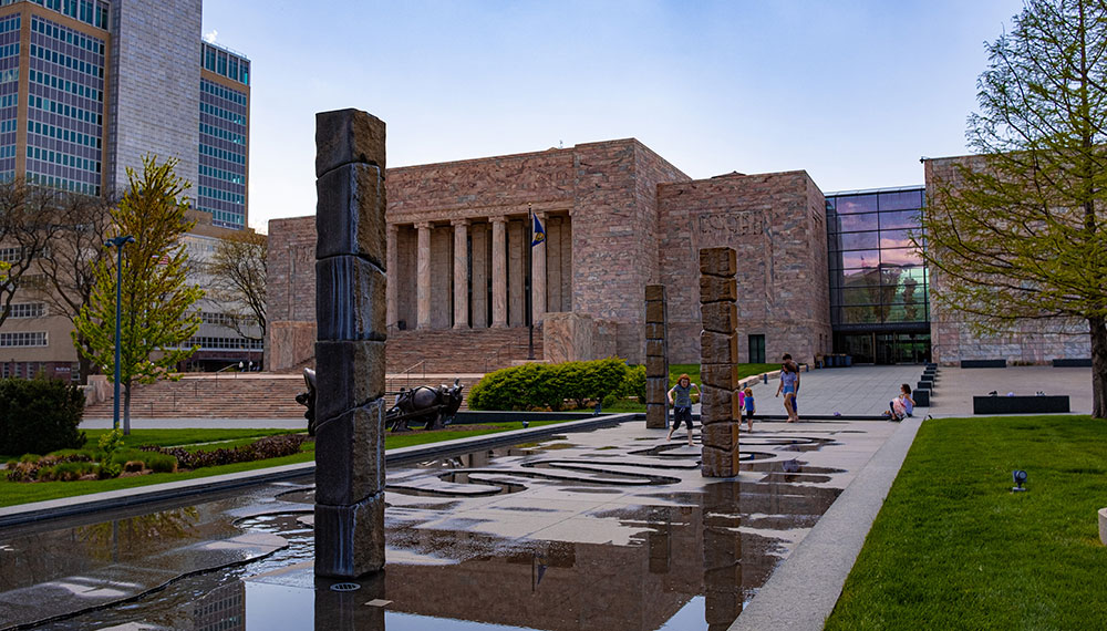 art museum building with trees and flowers surrounding