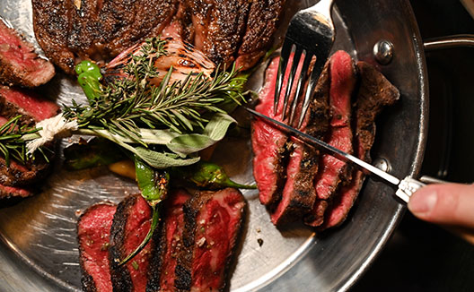 steak being cut on a plate