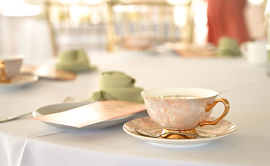 teacup, saucer, and spoon on a table
