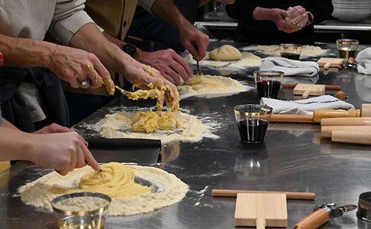 people making pasta in a cooking class
