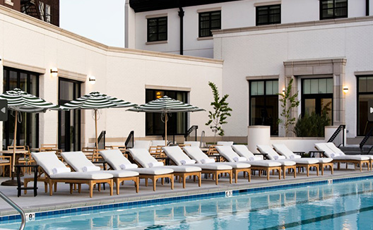 chairs next to a pool