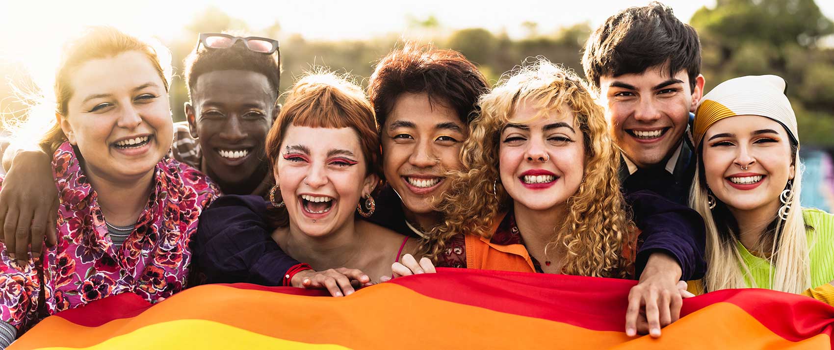 people in front of pride flag